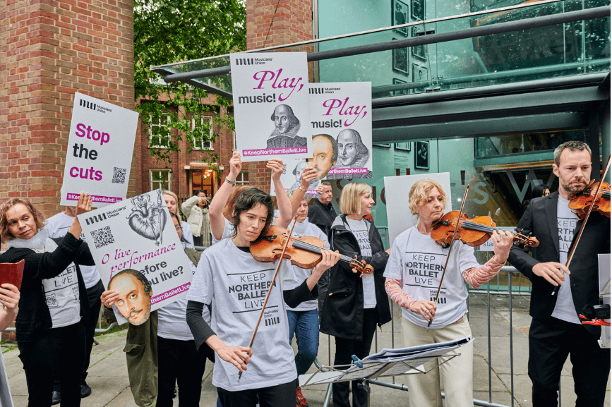 musicians holding placards and playing violins #ProtectNorthernBallet Fund the Arts