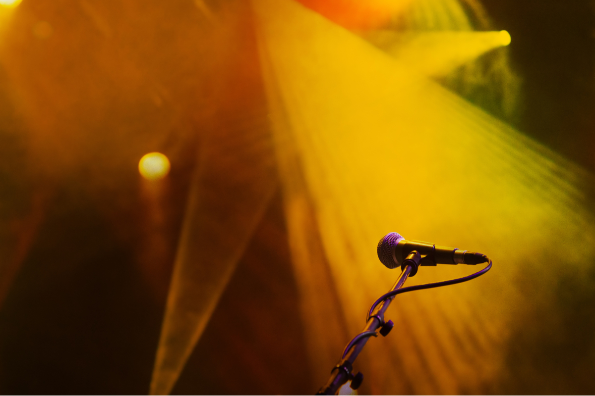 Microphone in yellow and orange stage lights