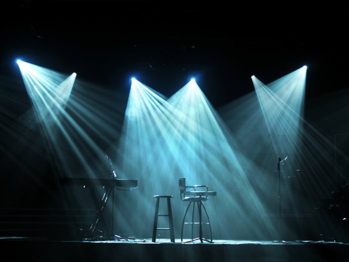 Stage with bright lights and microphones ready for concert