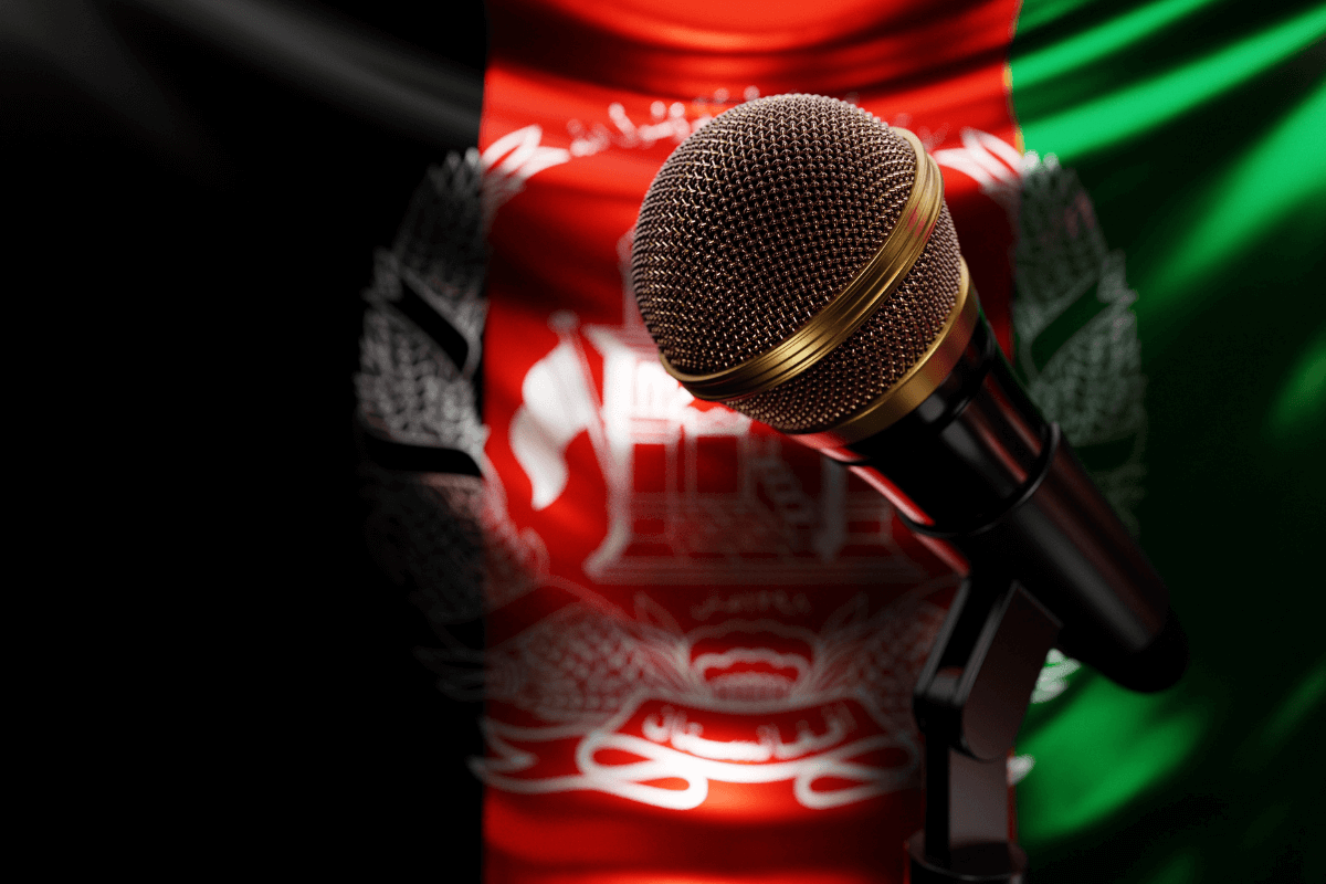 Microphone on the background of the National Flag of Afghanistan, realistic 3d illustration.