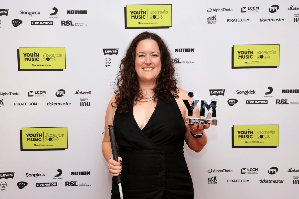 Kathryn, smiling stood holding the award.