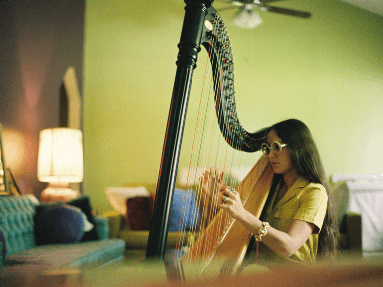 young woman practising harp. Musician Practices By Cinema Tigers