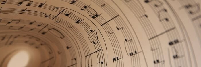Close up of curled music sheet with notes.