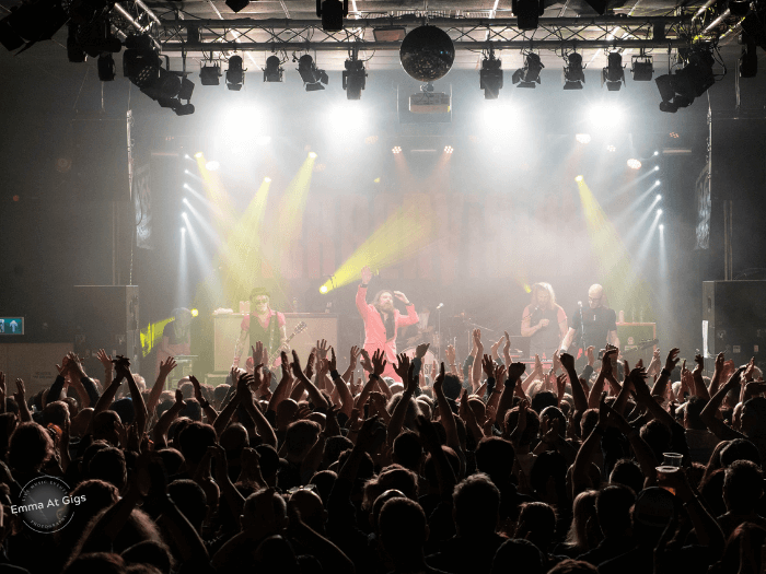 A band onstage, in front of a packed crowd at The 1865.