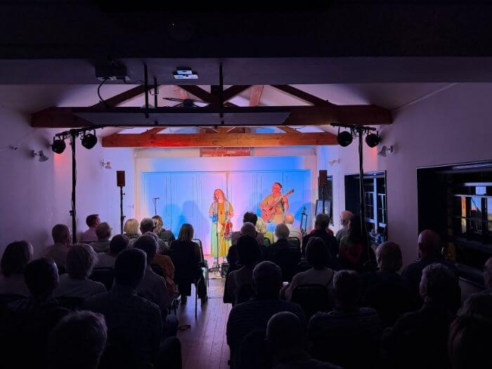 Musicians performing at the Sudbury Sessions venue in front of the audience