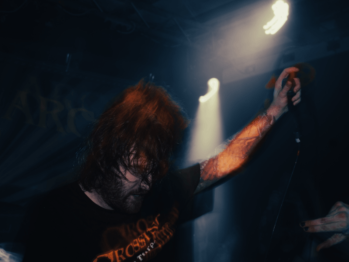 An out of focus photo of an audience member at a live gig.