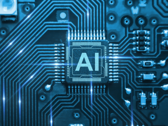 A circuit board with a card saying AI in the middle.