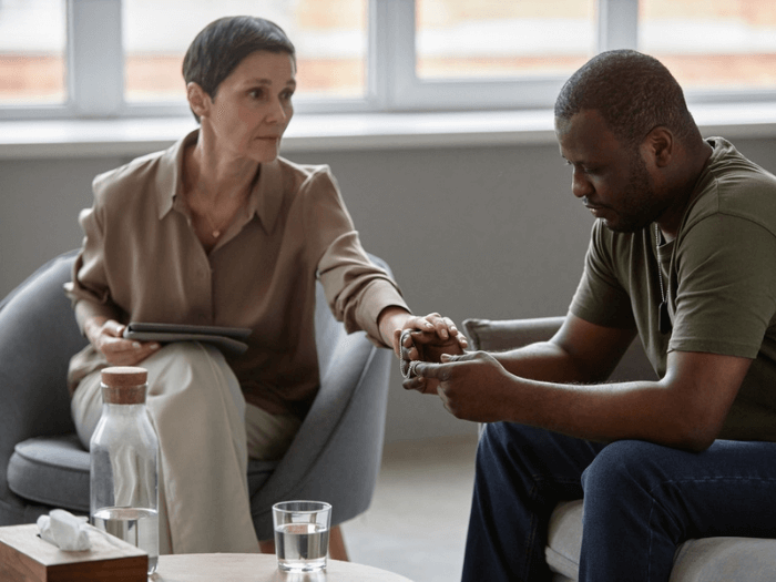 A grief counsellor offering support to a patient.