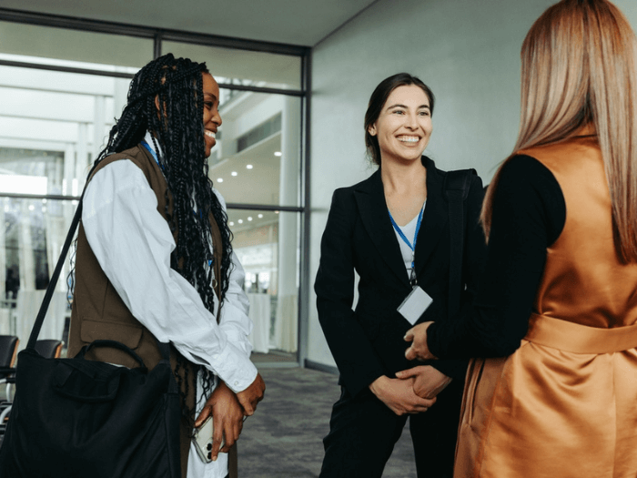 Three women meeting at a networking event.