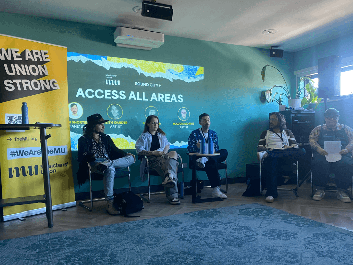 MU Head of ED&I John Shortell, and activists and musicians Maddie Morris, Stu and Keith Xander at the 2025 panel event.