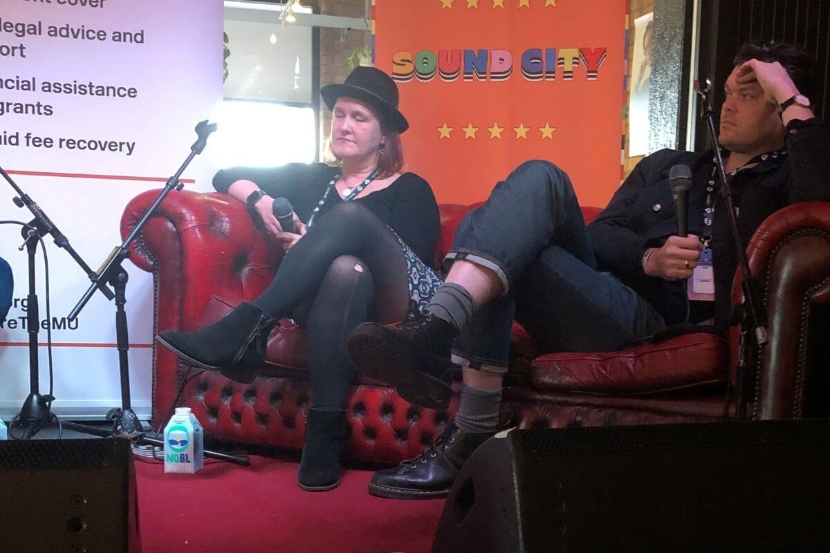 Annabella Coldrick and Jeremy Pritchard on a sofa during the panel event.