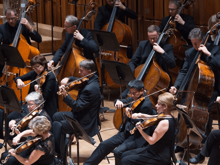 Musicians playing string instruments as part of BBC Symphony Orchestra.