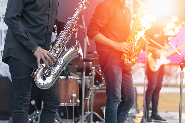 Photograph of a jazz band performing outdoors.