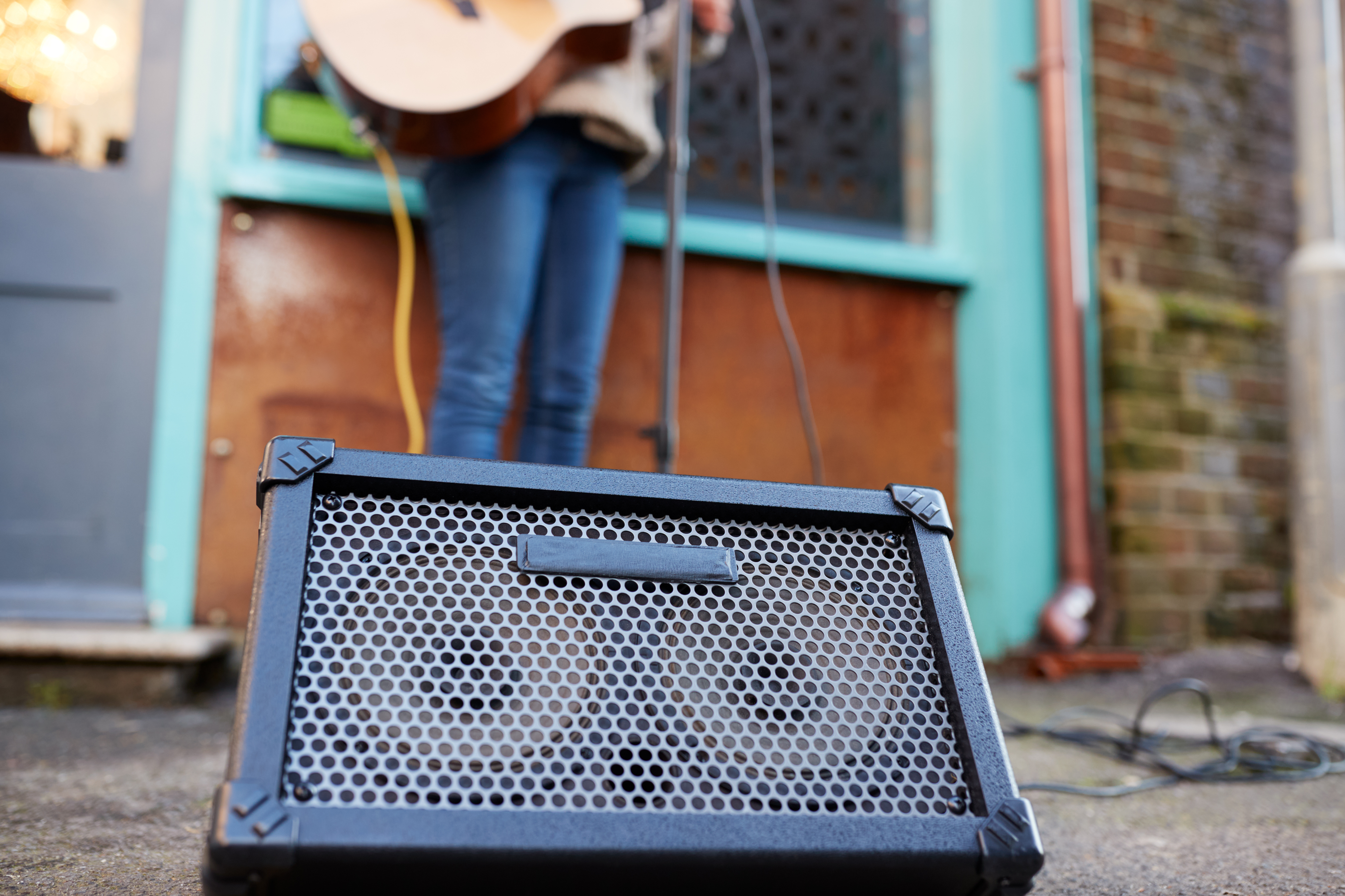 Photograph of a busker with an amp.