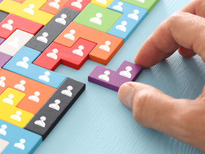 Coloured wooden blocks representing people and community.