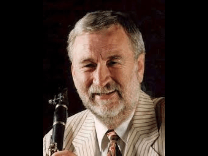 Portrait of Chris Walker holding a clarinet.