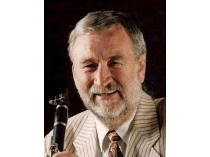 Portrait of Chris Walker holding a clarinet.