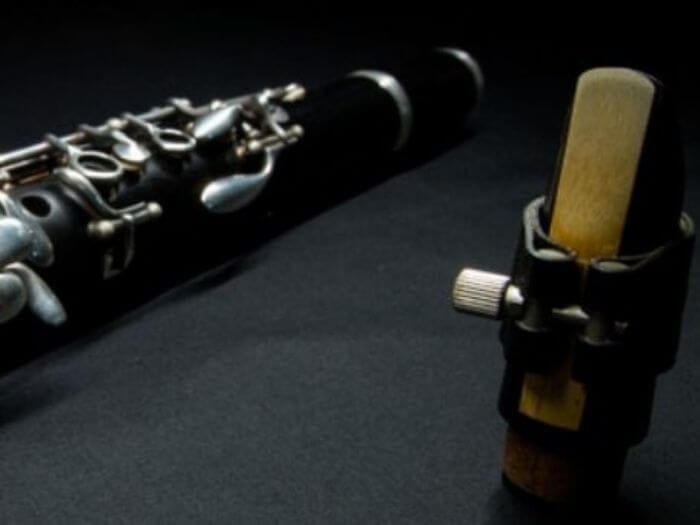 Clarinet with close up of detached reed mouthpiece.