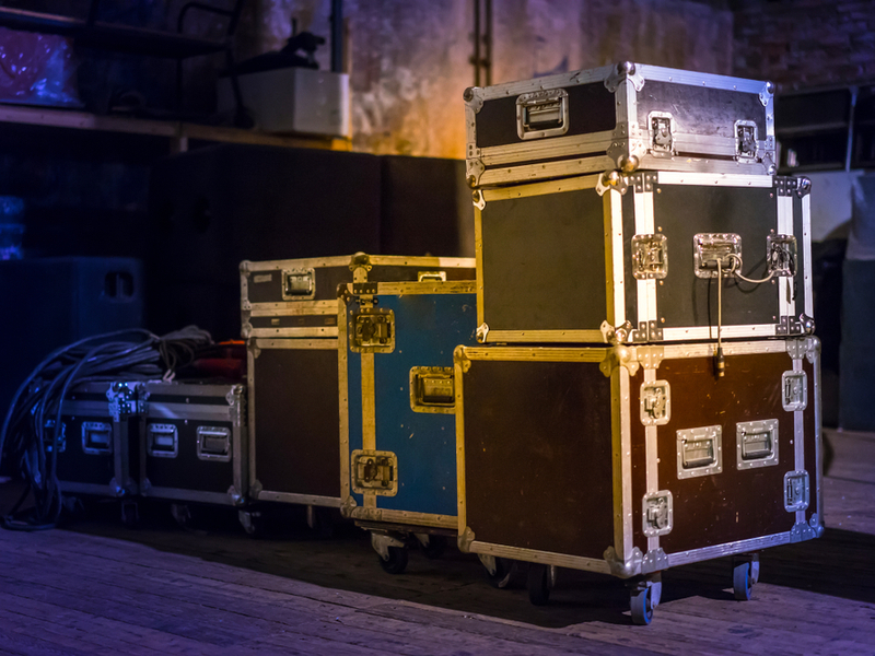 Photograph of a number of travel crates ready to pack concert equipment in for a tour.