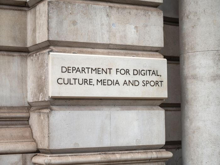Entrance sign to the UK government building for the DCMS on London's Whitehall, England.