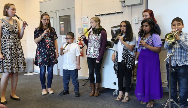 Group of young musicians with physical disabilities playing various instruments