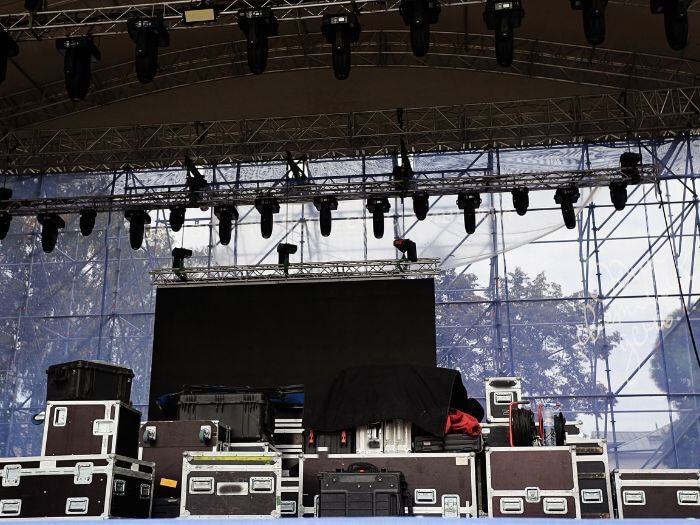 Empty outdoor stage with sound equipment set up.