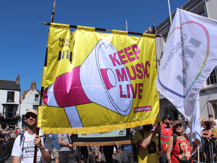 Last year's parade, MU members holding a large banner that says 
