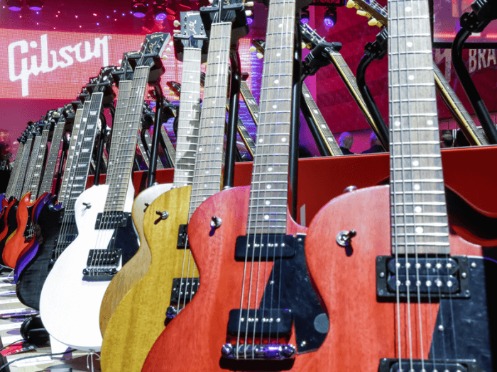 Close up of a range of Gibson guitars at a guitar exhibition.