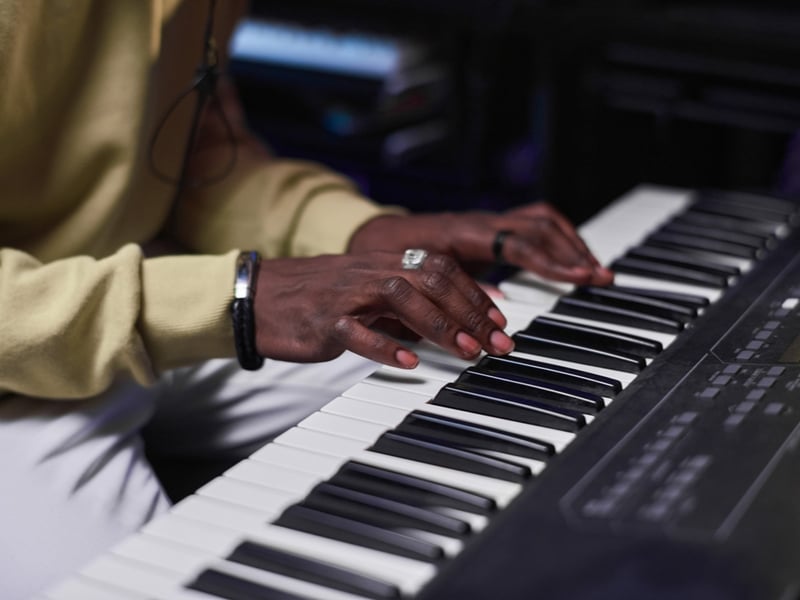 Hands playing on an electronic keyboard