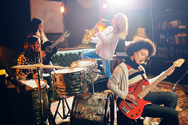 Musicians playing in a home studio setting. Photo credit: Shutterstock