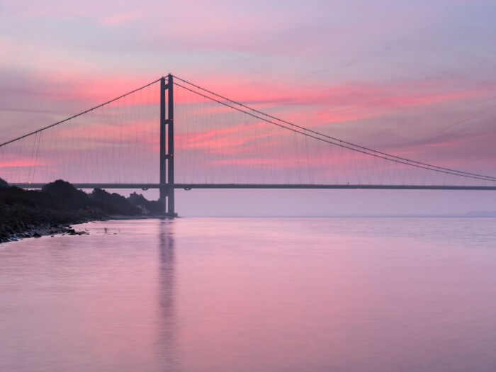 Pastel red sunrise over the Humber Bridge in Hull