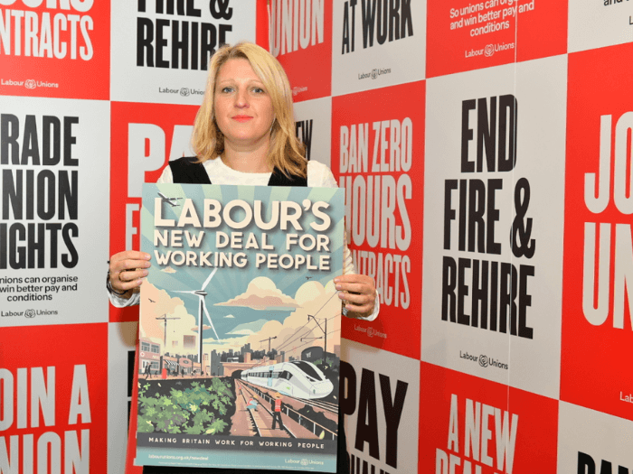 MU General Secretary Naomi Pohl holding a poster saying 'Labour's New Deal for Working People' at last year's Labour Party Conference.