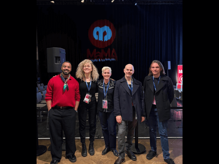 The five panellists stood together in front of the MaMA stage before the event.