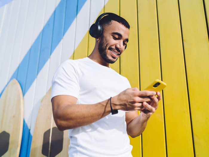 a man browsing Instagram with his headphones on