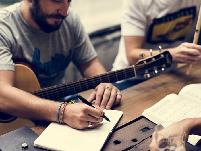 two Men with Guitar Writing a Song