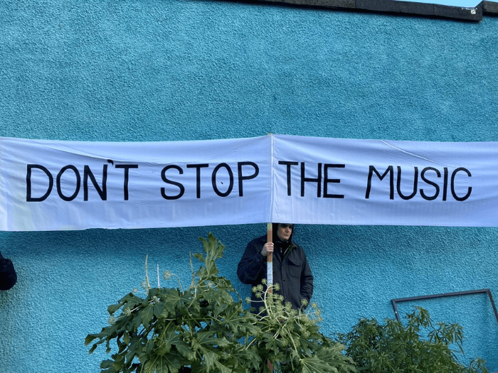 Large white banner saying 'Don't stop the music'.