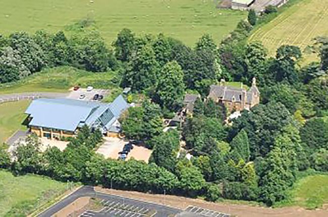 Aerial shot of the Stables venue in rural, green environment.