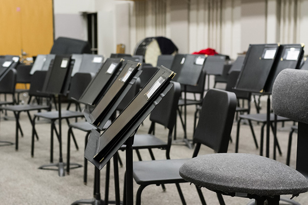 Empty classroom with chairs and music stands.