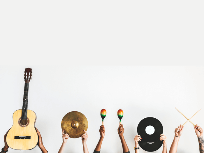 5 people holding instruments up against a grey background, only the hands on display. Left to right, acoustic guitar, drum symbol, maracas, vinyl disks and drum sticks.