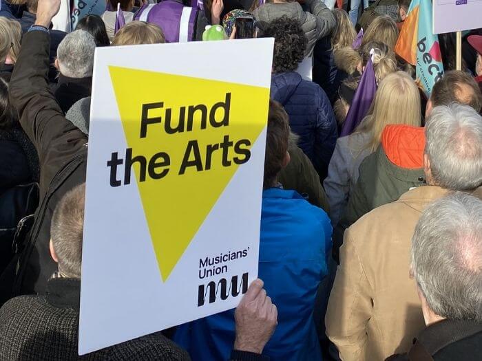 Close up of 'Fund the Arts' placard from one of the MU's previous Arts Council Funding marches.
