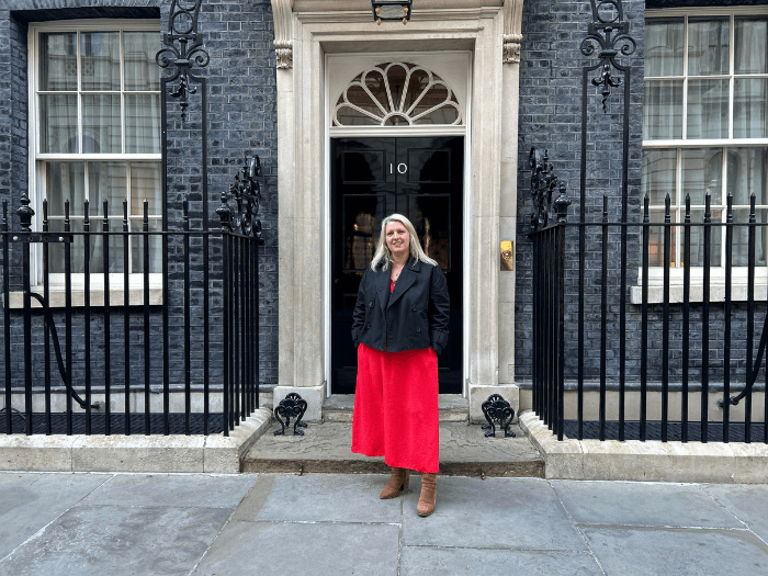 Naomi Pohl standing in front of No. 10 Downing Street.