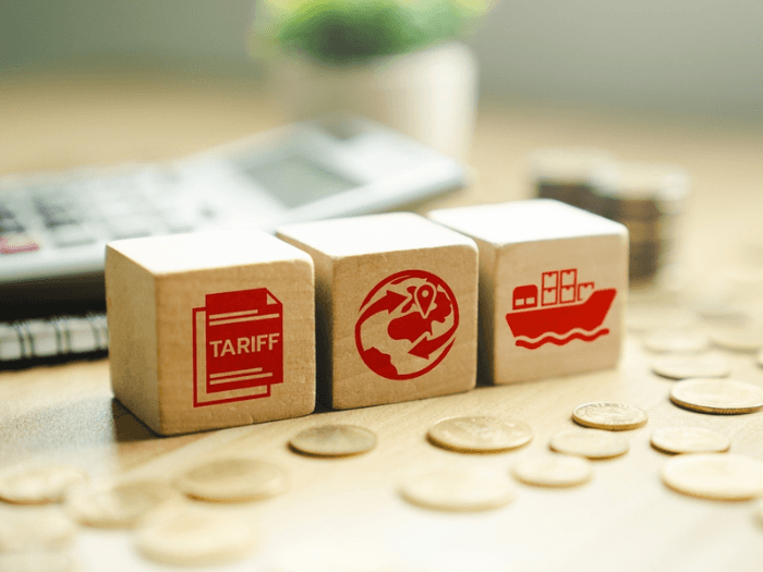 Three wooden blocks with red icons painted on them.