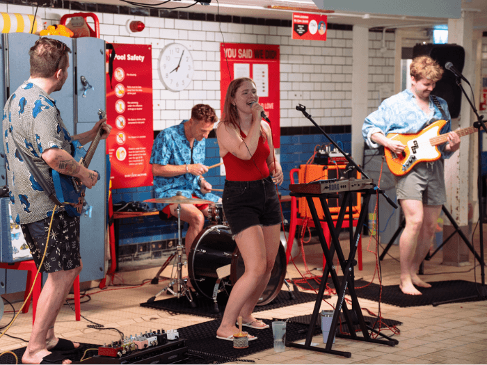 Close up of Poppy and her band performing poolside.