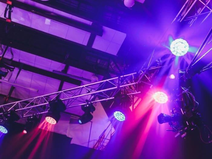 Purple spotlights above a stage.