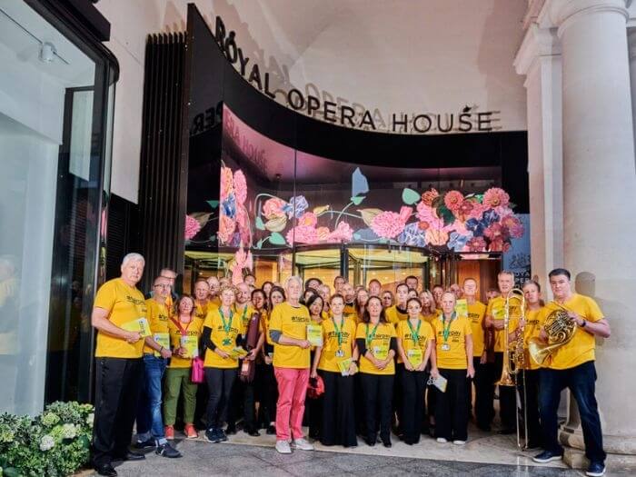 The Royal Opera House orchestra wearing yellow FairPay t-shirts outside of the entrance to the building from their leafleting campaign in September..