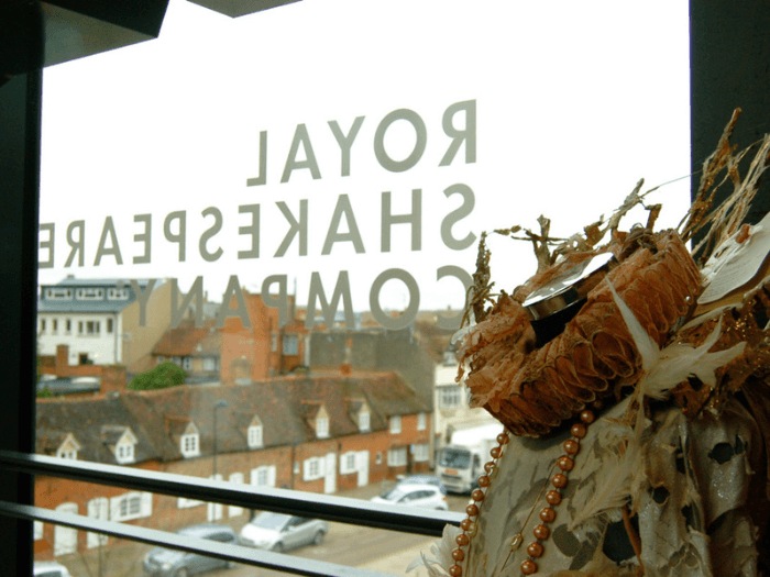 View from the second floor of the Royal Shakespeare Theatre with a period costume in the foreground.