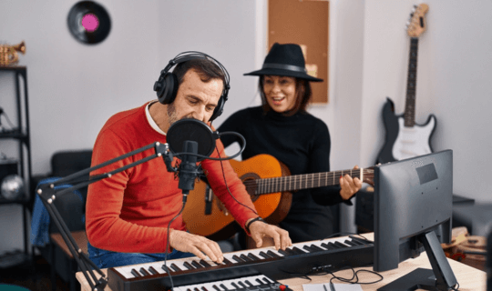 Two musicians playing keyboard and guitar together.