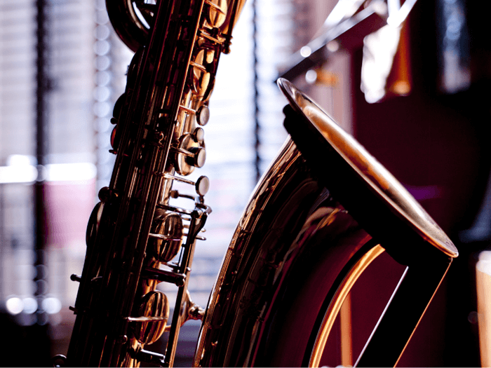 Close up of baritone saxophone, back ground is out of focus.