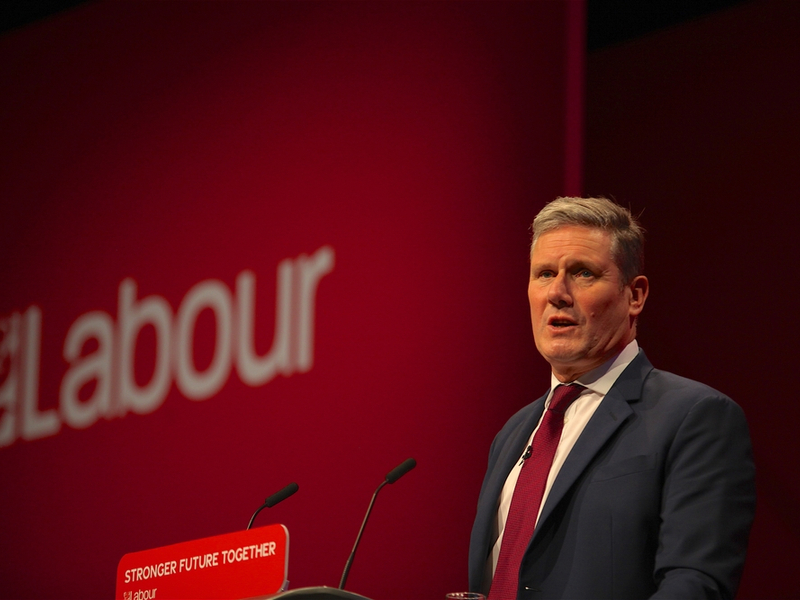 Photograph of Keir Starmer speaking at the Labour Conference, against a 