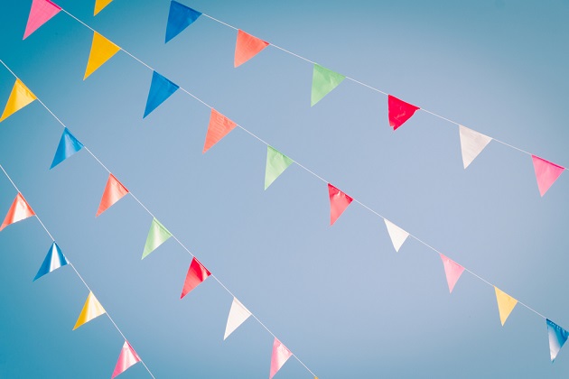 Multi coloured bunting flapping in the blue sky